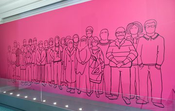 Outline mural of Citizen's Jury participants on a pink wall