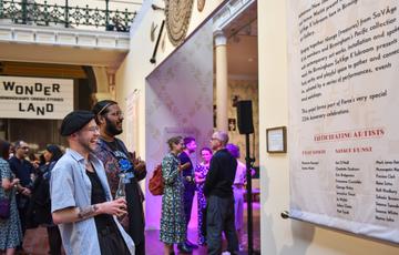 Two guests at a BMAG evening event looking at the Industrial Gallery Displays