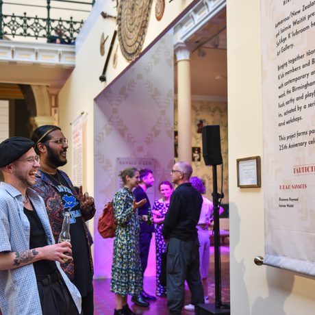 Two guests at a BMAG evening event looking at the Industrial Gallery Displays