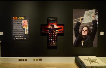 Introduction panel with cross and walk of fame next to it.