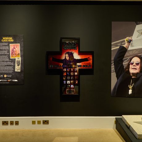 Introduction panel with cross and walk of fame next to it.