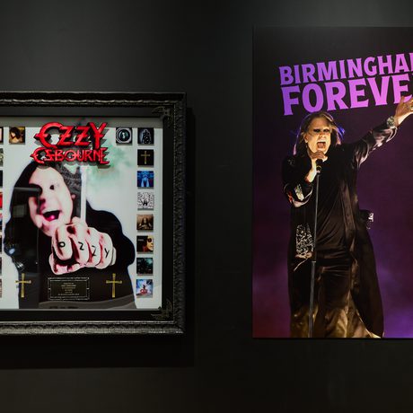 A large photo of Ozzy Osbourne with the text Birmingham Forever. Next to a framed albums.
