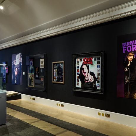 A view of the wall with a display case of awards to the side.