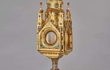 Ornate gothic style reliquary with crucifix final on Byzantine style roof studded with precious stones and enamel.