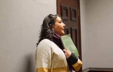A staff member showing a booklet.