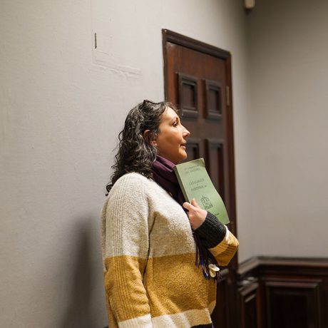 A staff member showing a booklet.