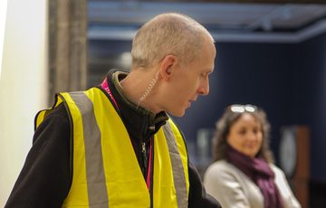 A staff member wearing a high vis vest.