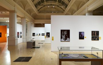 Spacious gallery showcasing photographs and displayed cases.