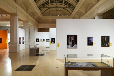 Spacious gallery showcasing photographs and displayed cases.