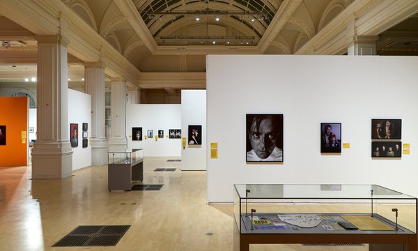 Spacious gallery showcasing photographs and displayed cases.