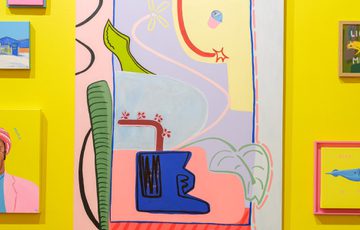 Abstract and colourful modern art pieces arranged on a bright yellow wall.