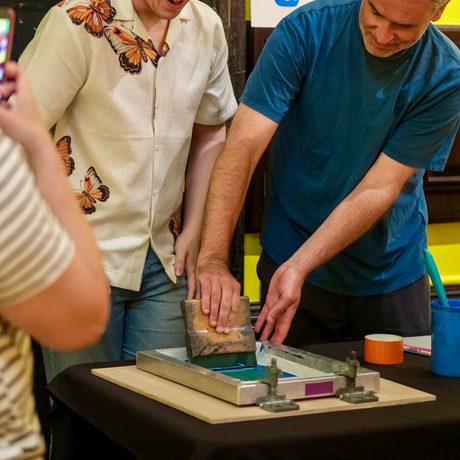 Two men collaborating on a screen printing project.