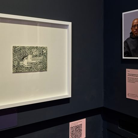 Drawing and photographic portrait on display.