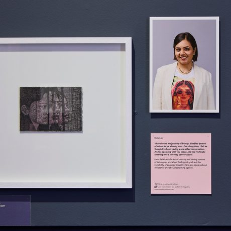 Close up of a drawing and portrait photograph on display.