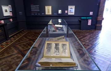 A display case with artwork book on display.