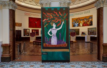 Two archways into the Round Room with an embroidered artwork in the centre between the arches.