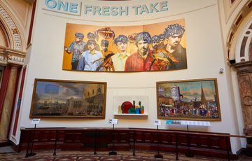A group of four large paintings hanging on the wall with the title 'One Fresh Take'.