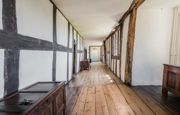 A long wooden hallway with wood.