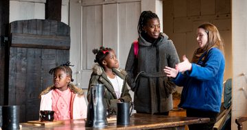 A BMT staff member telling a family about the Great Hall at Blakesley