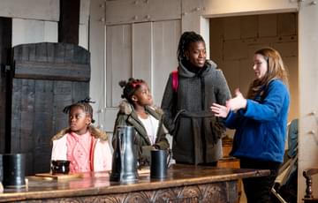A BMT staff member telling a family about the Great Hall at Blakesley
