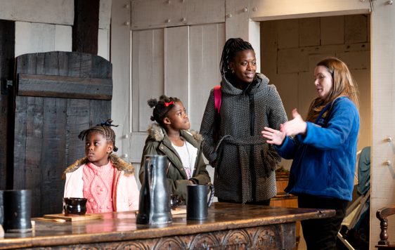 A BMT staff member telling a family about the Great Hall at Blakesley