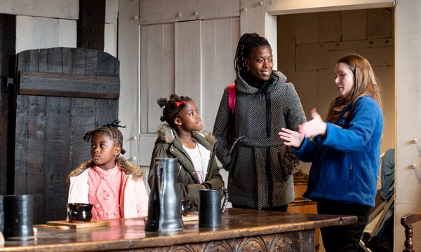 A BMT staff member telling a family about the Great Hall at Blakesley