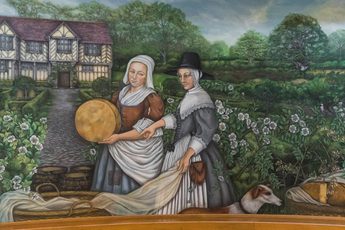 A painting of two Tudor women in the gardens at Blakesley Hall.