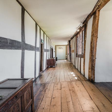A long wooden hallway with wood.