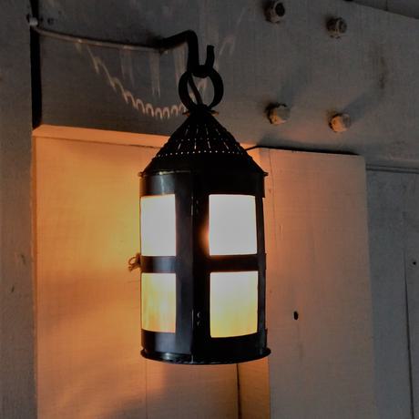 Close up of a lantern that is lit with a candle.