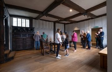 Visitors in the Great Hall at Blakesley Hall.