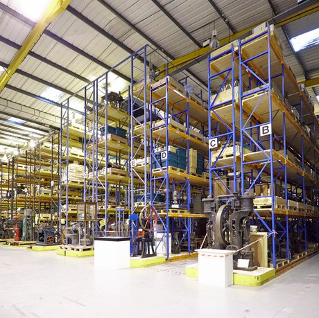 A large warehouse of artefacts on racking that goes to the ceiling.