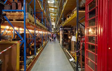 Warehouse racks containing old examples of machinery