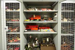 Storage cage containing vintage metal toy cars and trains