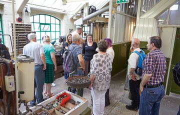 A group of people on a tour in a factory.
