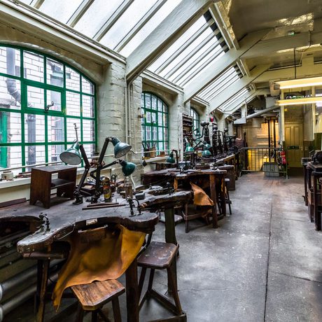 Groups of workbenches with tools in a historic workshop