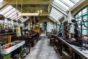 Industrial workshop with glass roof containing metal turning machinery and metal presses