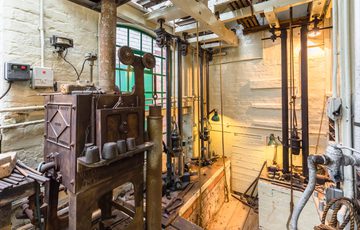 Historic tools and machinery in a workshop.
