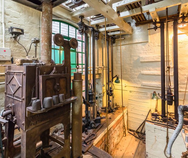 Historic tools and machinery in a workshop.