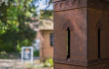 Close up of a sculpture of a tower in the grounds of Sarehole Mill.