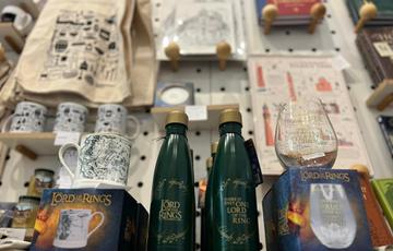 A selection of Lord of the Rings items on display in a shop. Including a mug, bottle and glass.