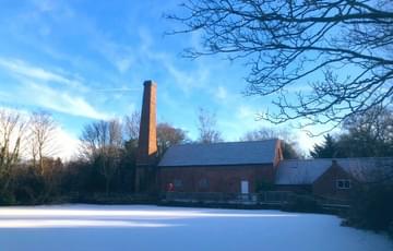 Sarehole Mill millpond covered with snow.