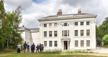 Soho House, a white Georgian House, with a group of people outside