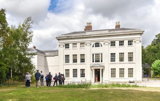 Soho House, a white Georgian House, with a group of people outside