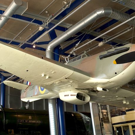 A Fighter Aircraft on display suspended from the ceiling, the view is from below.