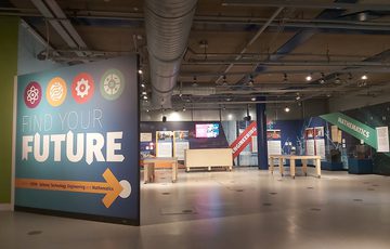 A gallery space with a large sign with 'Find your Future' on the entrance.