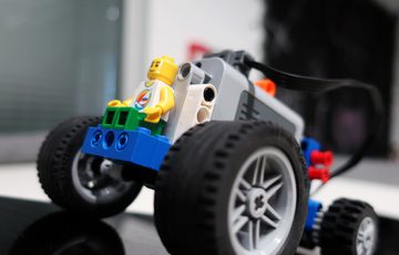 LEGO car with LEGO person at the front