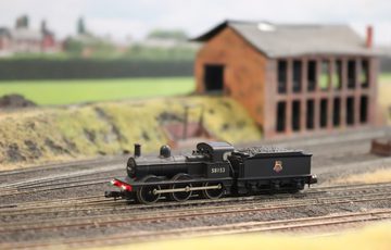 A close up of a model train on a track.