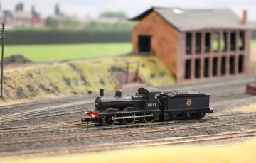 A close up of a model train on a track.