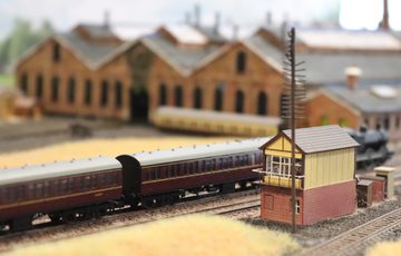 A close up of model train carriages on a track.