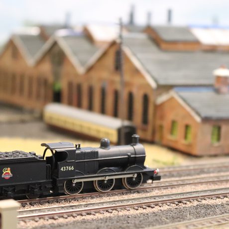 A close up of a model train on a track.